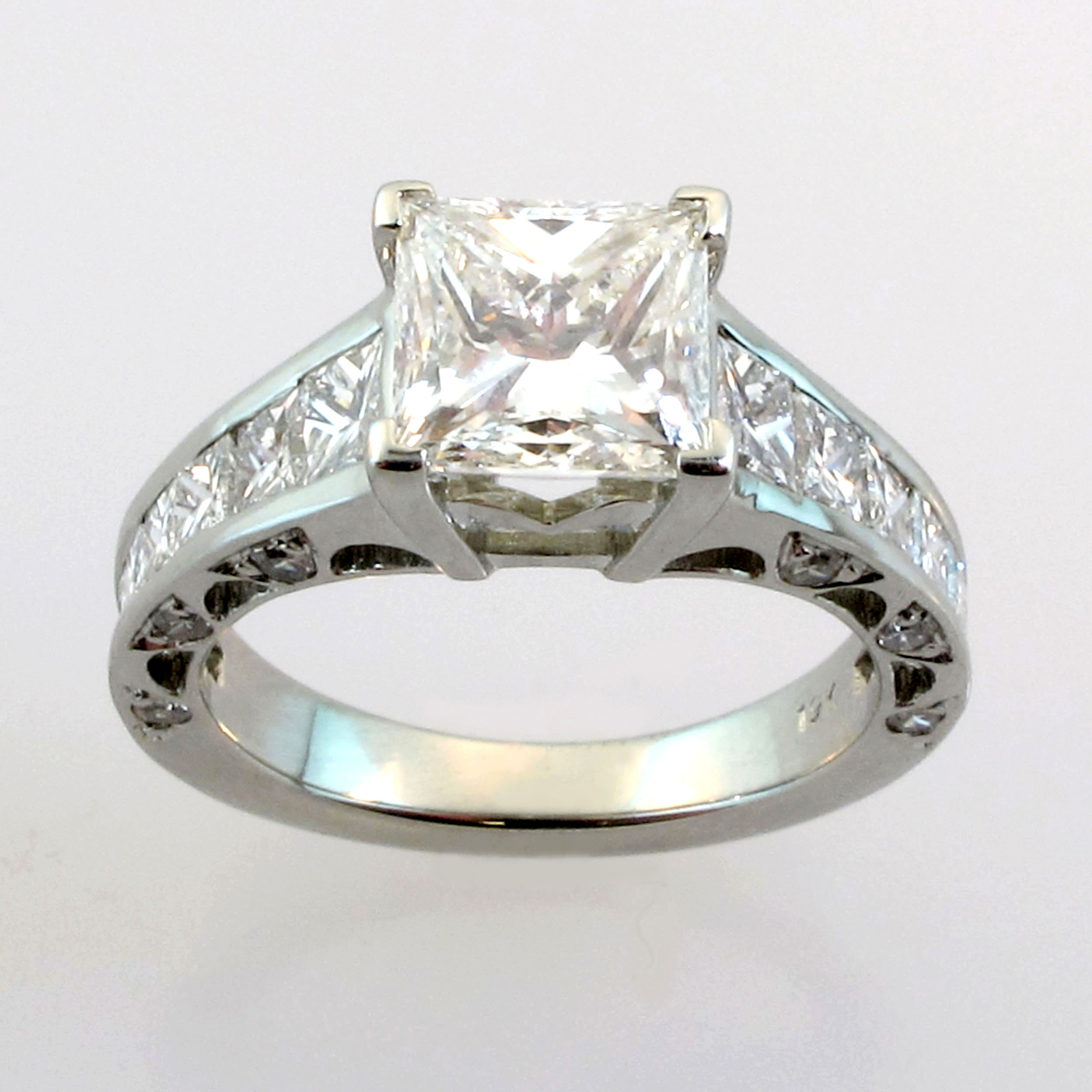 Engagement ring with wide band 4-prong channel set princess cut with side diamonds