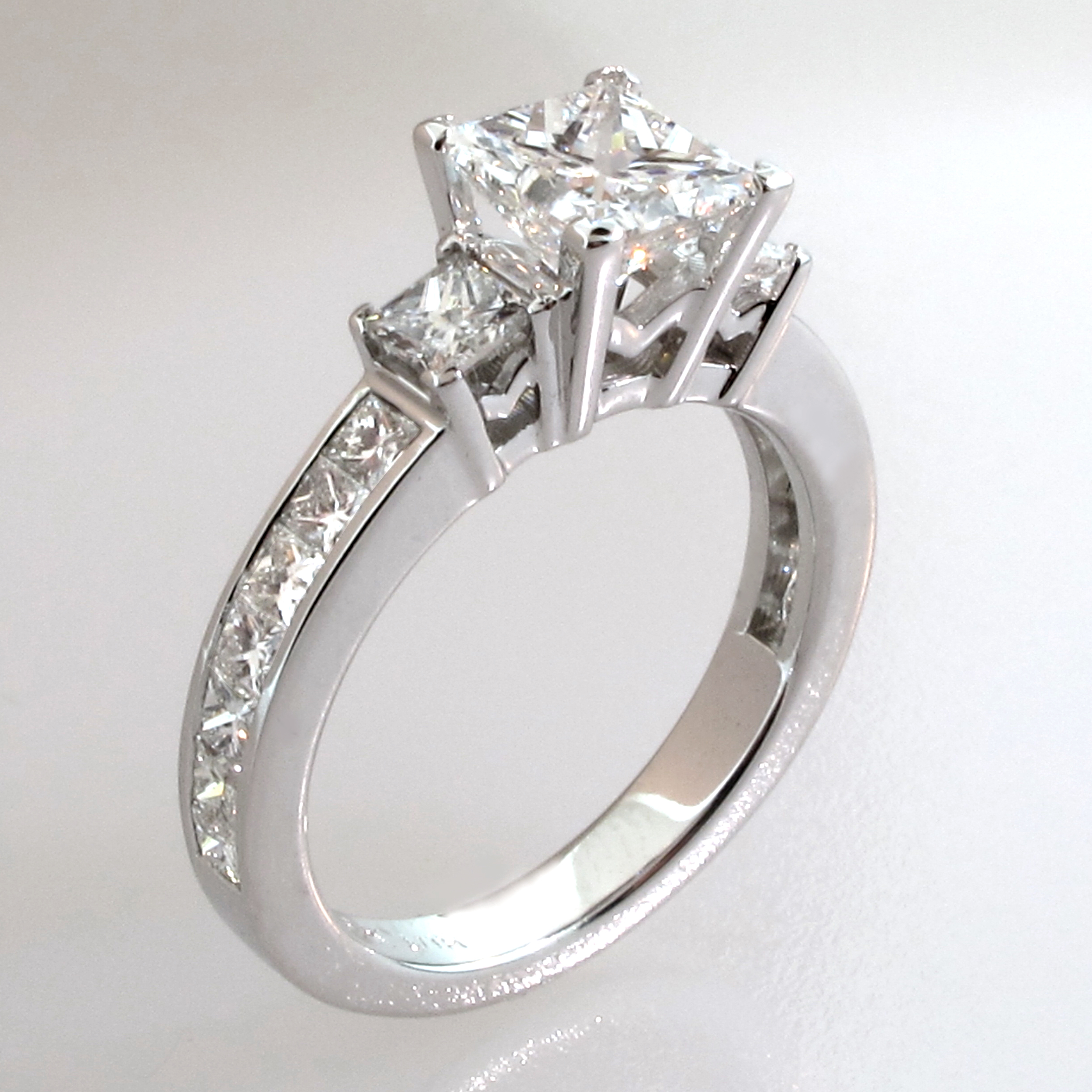 Engagement Ring Princess-Cut center stone with 2 side diamonds 19k white gold channel-set